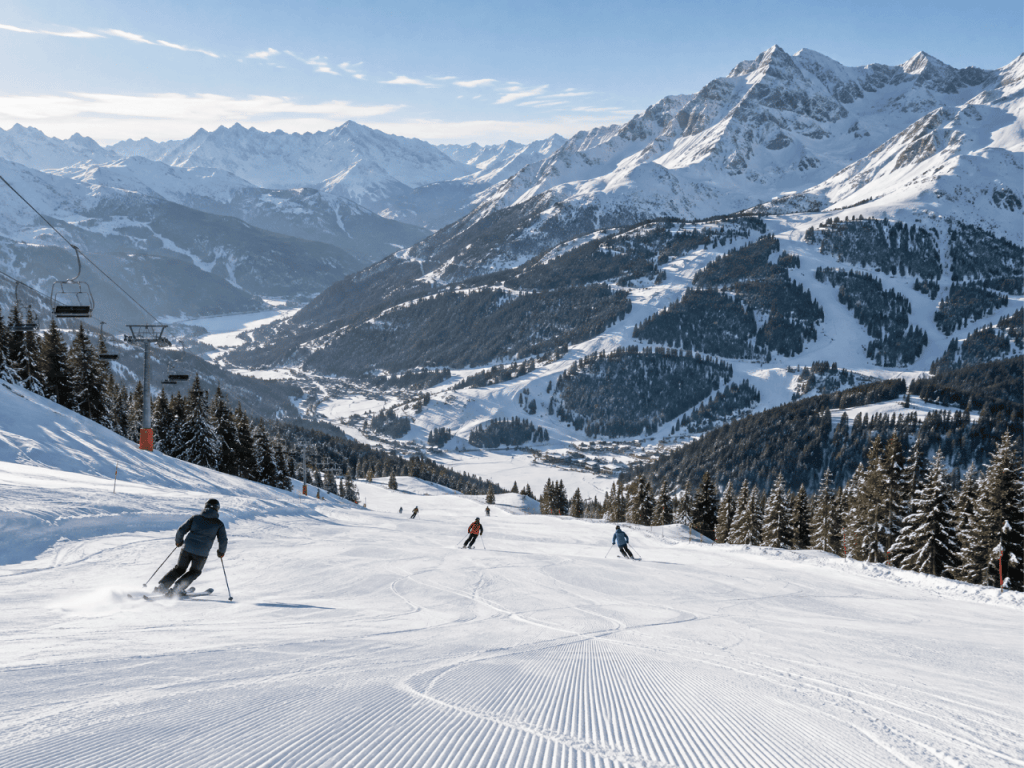 Alpine mountain range with snowy peaks and pine forests