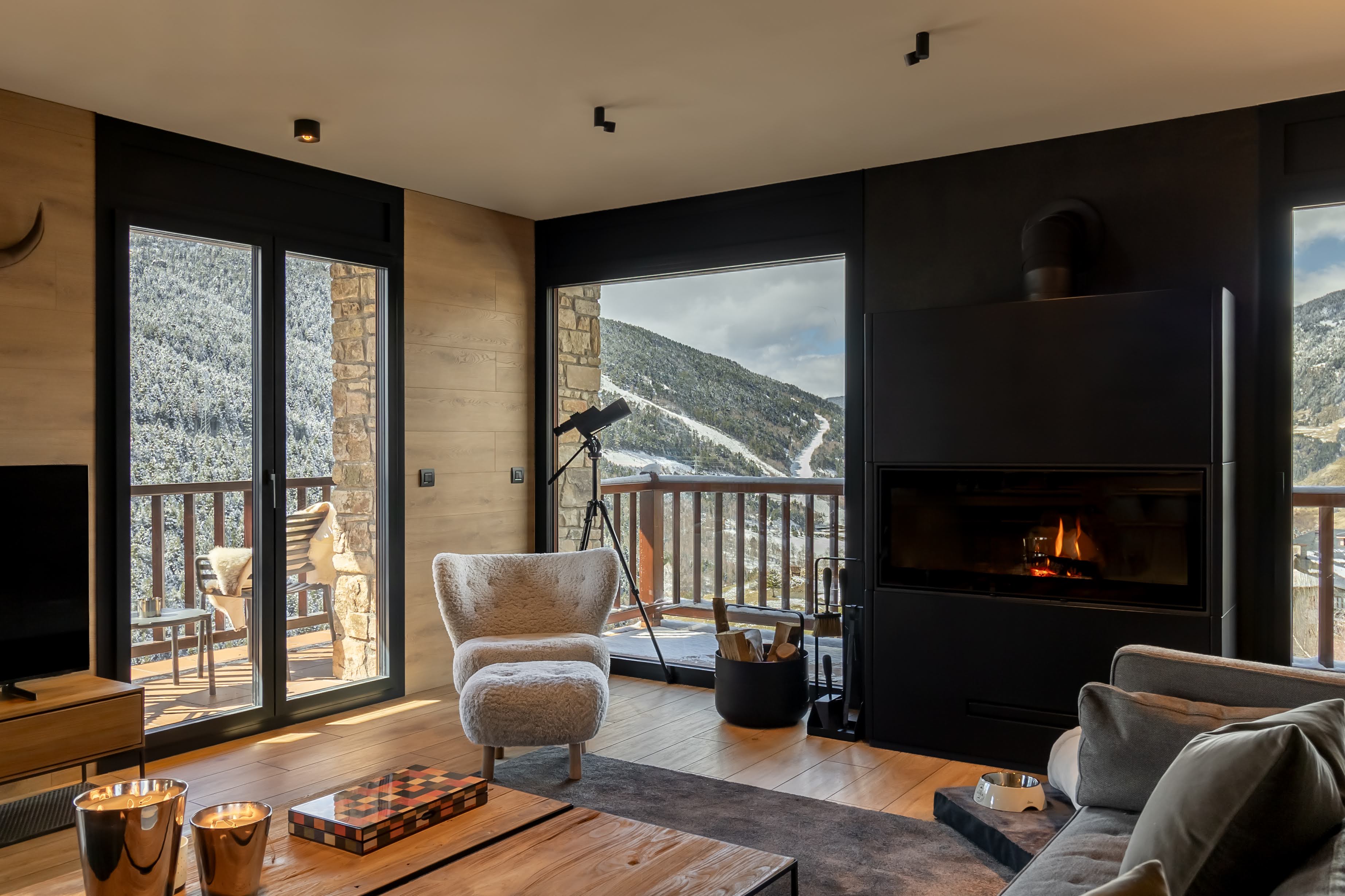 Spacious living area with wood fireplace in luxury ski apartment