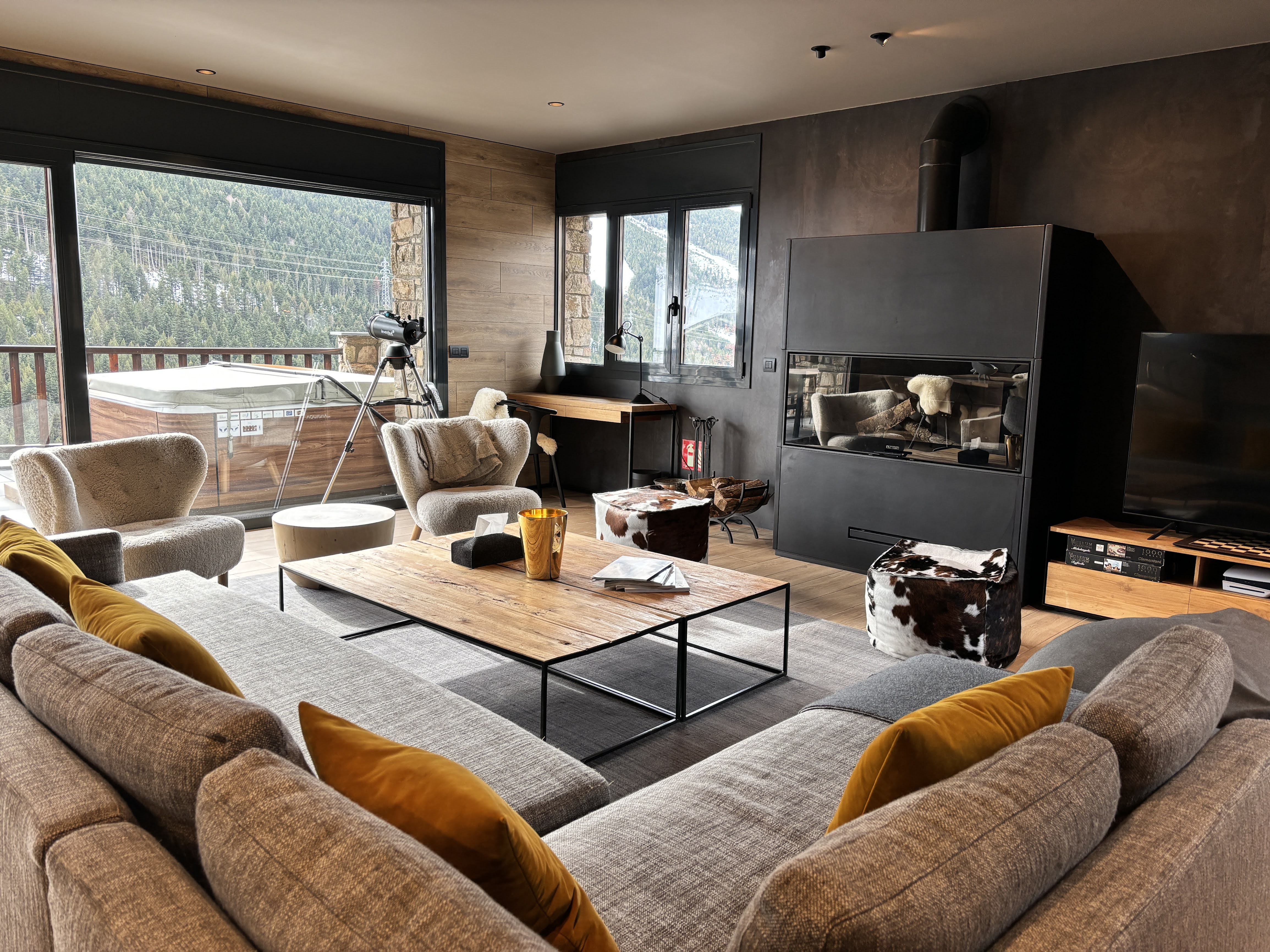 Luxury ski chalet living room with fireplace and mountain views